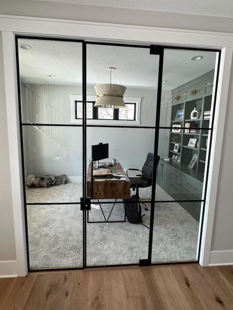 Black grid glass doors into a home office