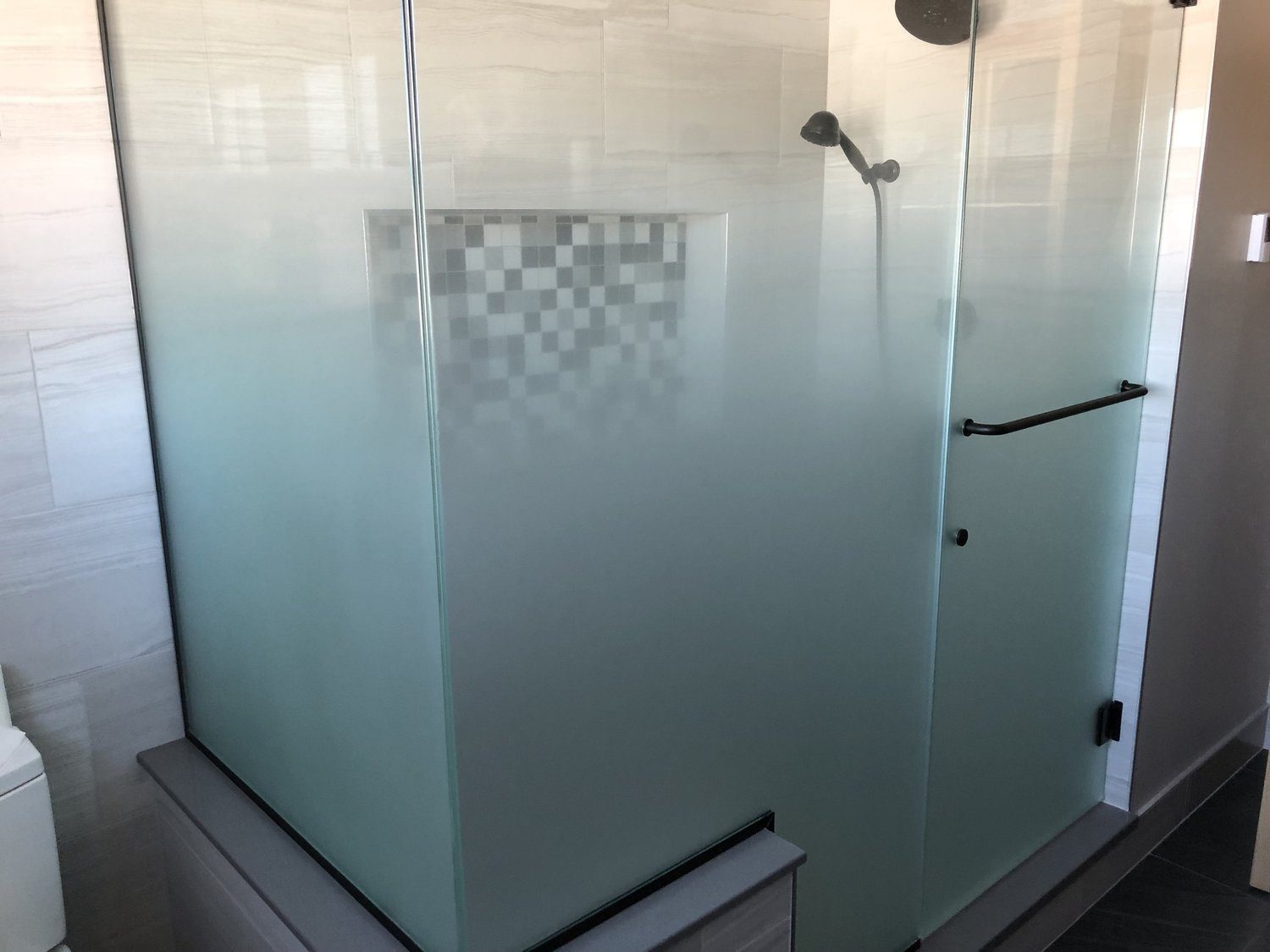 Frosted frameless shower enclosure