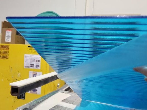 Sheet of transparent blue back-painted glass on the paint line
