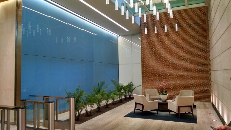 Blue back-painted glass wall panels in a building lobby