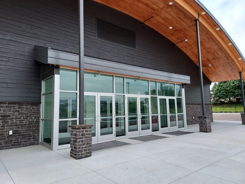 Aluminum storefront entrance with glass doors and sidelites